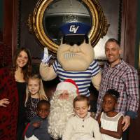 Family of six posing with Santa and Louie